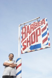 Barber in front of Barber Shop Sign & Barber Pole Barber in front of Barber Shop Sign & Barber Pole